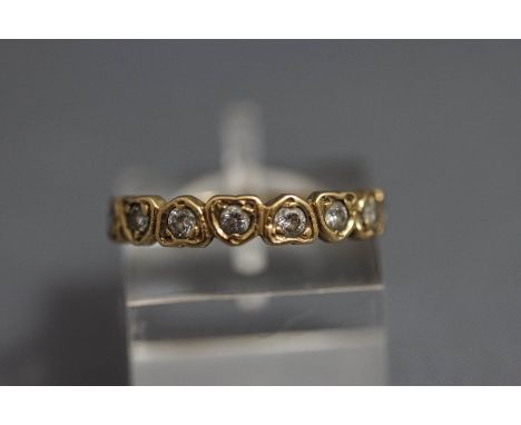 A 9 carat gold eight stone half hoop ring, the colourless synthetic stones set in heart shaped motifs, finger size J1/2, 1.4 