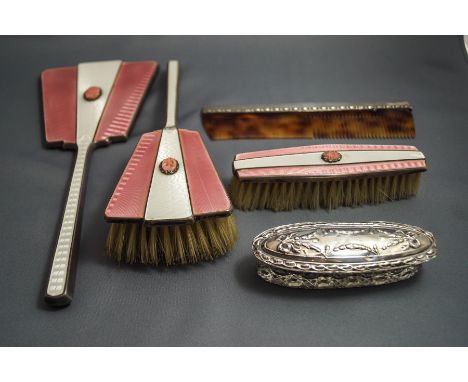 A silver and pink enamel three piece dressing table set, Birmingham 1937, the mirror and two brushes set with a simulated cor