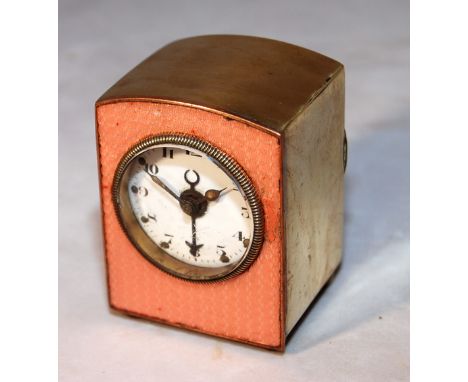 MINIATURE CLOCK WITH BRASS CASE AND PINK GUILLOCHE ENAMEL DECORATION . MECHANICAL MOVEMENT WITH ALARM FEATURE.HEIGHT 6.2 CM.