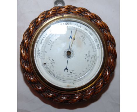 VICTORIAN OAK ANEROID BAROMETER WITH A 12.5CM WHITE DIAL, THE BAROMETER HAS A MERCURY THERMOMETER ENCLOSED.