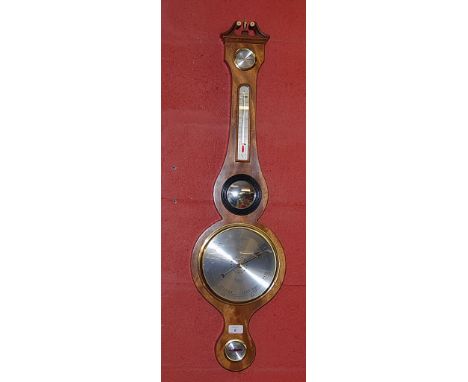 WALNUT BANJO BAROMETER BY "COMITY OF HOLBORN, LONDON" ANEROID MOVEMENT REGISTERING ON A SILVERED DIAL. THE BAROMETER HAS A TH