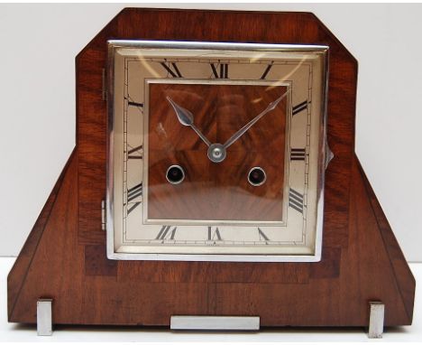 WALNUT CASED MANTEL CLOCK IN DECO PERIOD STYLE. SQUARE DIAL WITH ROMAN NUMERALS. CHIMING MOVEMENT STRIKING ON THE HOUR AND HA
