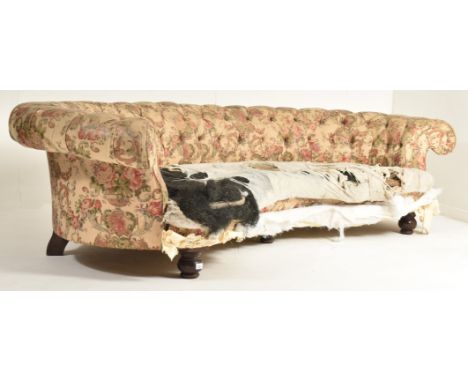 A large 19th century high Victorian crescent shaped Chesterfield sofa settee in the manner of Howard &amp; Sons. Low-curved b