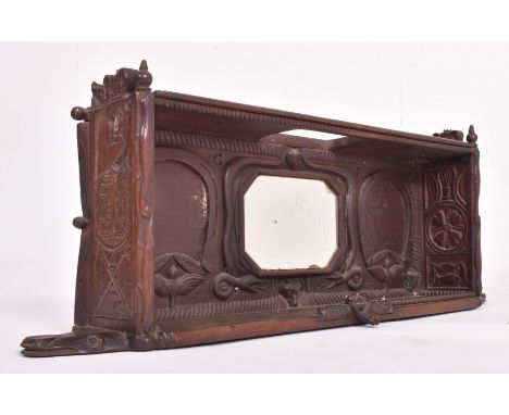 An Edwardian early 20th century 1903 carved ebonised wood hanging cupboard shlef with mirror. The shelf having an octagonal s