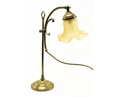 An Art Nouveau early 20th century brass &amp; glass desk table coaching lamp. The lamp having a flower shaped glass shade in 