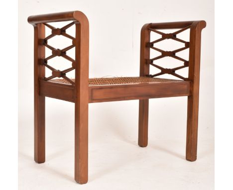 An early 20th century, Edwardian mahogany and rattan weave seat window seat bench. The bench having scrolled side supports wi