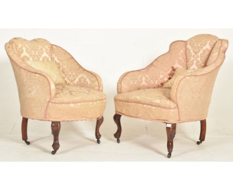 A near matched pair of Queen Anne Revival early 20th century upholstered armchairs. Each having a padded shell-shaped backres