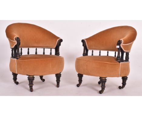 A pair of late Victorian Aesthetic Movement 19th century ebonised and gilt parcel wood spindle back tub armchairs. Each in ye