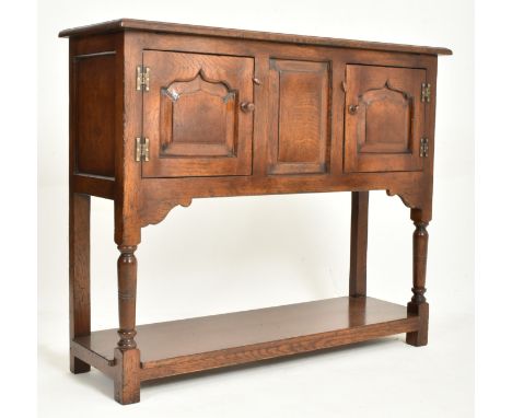 A 20th century George III Revival oak Ipswich credence cupboard - sideboard. The credence having a flared rectangular top wit