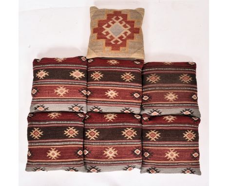 A collection of country house matched set of seven late 20th-century Kilim carpet squab cushions. Six matching examples with 
