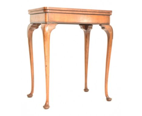 A Queen Anne Revival early 20th century walnut foldover card games table. The table having a rectangular fold over top openin