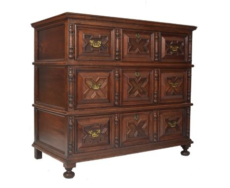 A 17th century Jacobean Commonwealth block fronted oak chest of drawers. The chest having a bank of three geometric moulded b