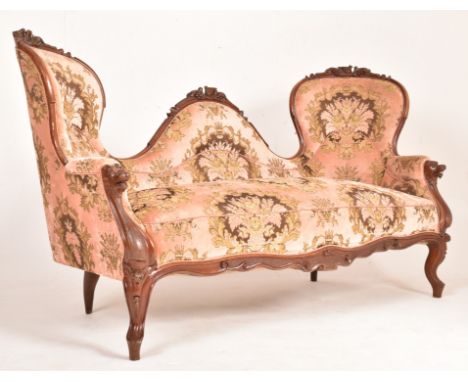 A late 19th century Victorian carved mahogany double-head sofa settee. The sofa having a carved double scrolll end back rests
