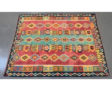 A 20th century Persian Anatolian Turkish Kilim floor carpet rug. The rug having a central panel with repeating polychrome geo