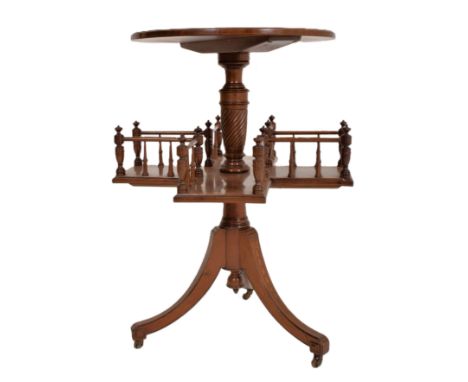 An Edwardian mahogany inlaid revolving book reading table. The table having a circular inlaid top with satinwood motifs to ce