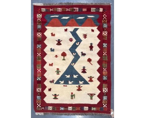 A 20th century South West Persian Islamic Qashgai Kilim floor carpet rug. The rug having a central shaped panel on a cream gr