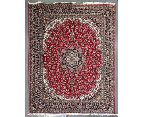 A large 20th century Iranian Islamic floor carpet rug. The rug having a red panel with floral shaped central medallion. Cream