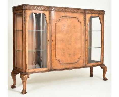 A Queen Anne Revival early 20th century walnut bow fronted glass breakfront display bookcase cabinet. The bookcase display ca