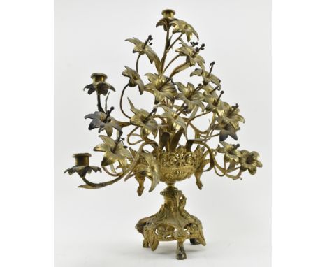 A large 19th century French Empire toleware gilt metal candelabra. The centrepiece featuring floral display raised over scrol