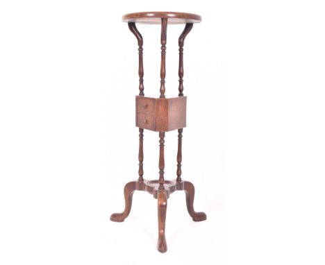 A George III late 18th century mahogany floor wig stand. The stand having a concave circular top with two drawer triangular u
