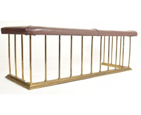 An early 20th century brass &amp; leather club fire fender. The fender having a padded brown leather seat with piped stitchin