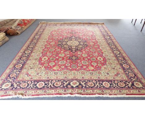 A large Persian Mahal carpet (modern): central cobalt blue teardrop medallion against a red field and light green spandrels, 