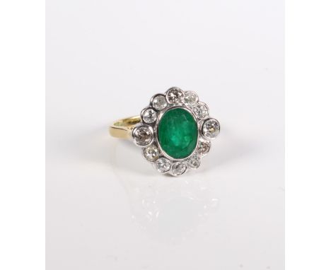 An 18-carat gold, emerald and diamond cluster ring.Ring size O. Setting in good condition overall, clear hallmarks. The emera