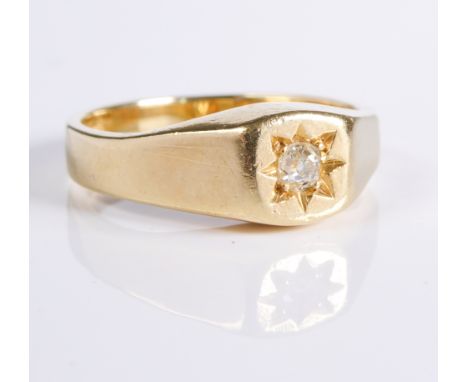 An 18-carat yellow gold diamond-set ring, the old brilliant-cut centrally set within a star motif to the tapering yellow gold