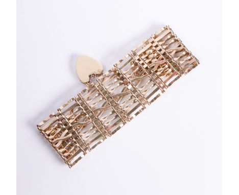 A vintage 9ct yellow gold gate link cuff bracelet: London 1966, with heart padlock clasp and safety chain (37g).
