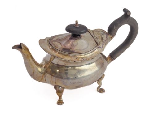 A small silver teapot with oval ebonised knop finial and carved ebonised scrolling handle: the underside of the hinged lid ha