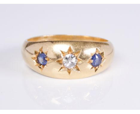 An antique 18ct yellow gold, sapphire and diamond three stone gypsy set ring: hallmarked Birmingham 1919, the central old bri