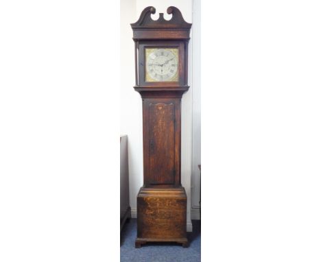A George III period oak-cased 30-hour longcase clock: the broken swan-neck pediment above a 12-inch brass and silvered dial f