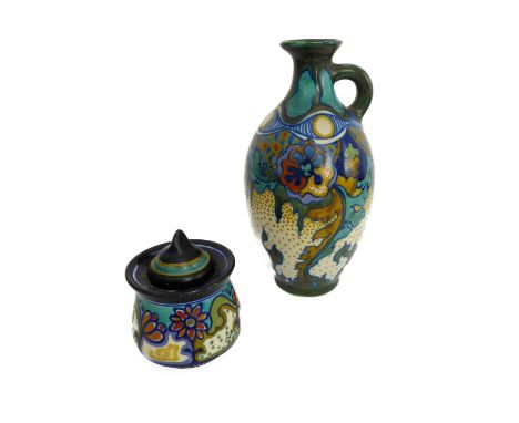 A Gouda Pottery jug of baluster form and strikingly decorated with various designs and stylised floral patterns (18 cm high).