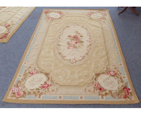 A fine and large French Aubusson tapestry: central cream oval with a spray of roses surrounded by scrolling acanthus and four