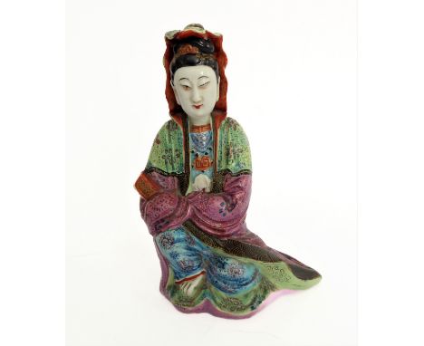 An 18th/19th century Chinese pottery model of a seated Guanyin: green and purple long flowing robe,&nbsp;serene expression an