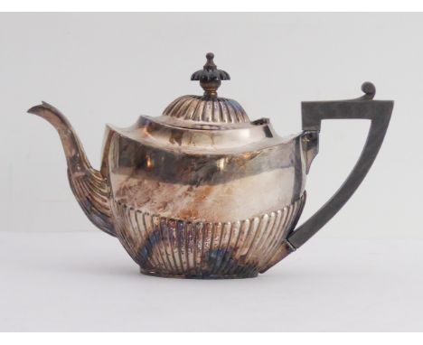 A hallmarked silver teapot in Georgian style: gadrooned lower base, early 20th century, Birmingham assay marks. (Total weight