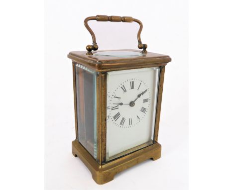 An early 20th century brass carriage clock timepiece: white-enamel dial with Roman numerals and with French movement (11.5 cm