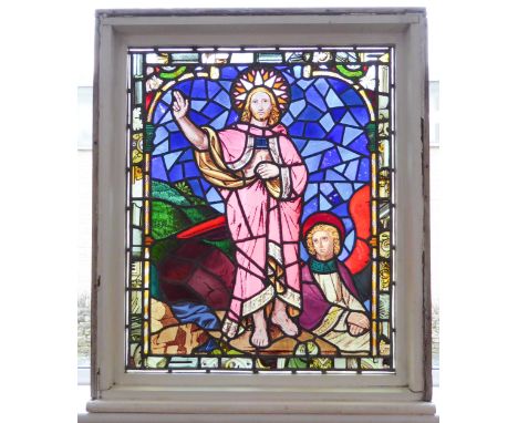A later framed stained glass window panel: the standing Christ figure with halo and dressed in long pink robe and holding his