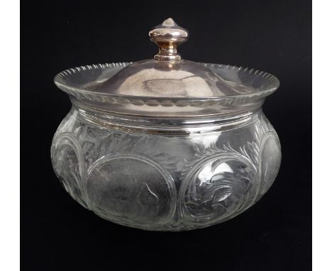 A George V cut and engraved glass powder-bowl with silver lid: the bun-shaped bowl decorated with leafy scrolls and engraved 