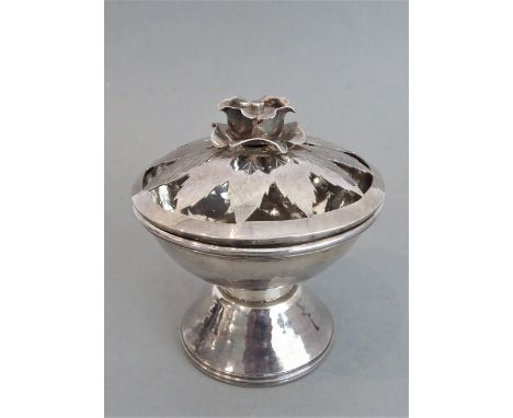 An Arts & Crafts style hallmarked silver pedestal rose style bowl: the cover with rose finial centring pointed leaves and abo