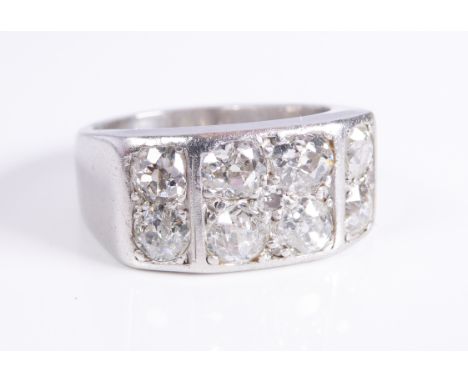 A platinum/white gold ring (unmarked): set with two bands of four horizontal diamonds, ring size I/J