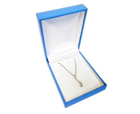 A 9-carat white gold pendant of curved form and mounted with five small diamonds, upon a 9-carat white gold chain (boxed)