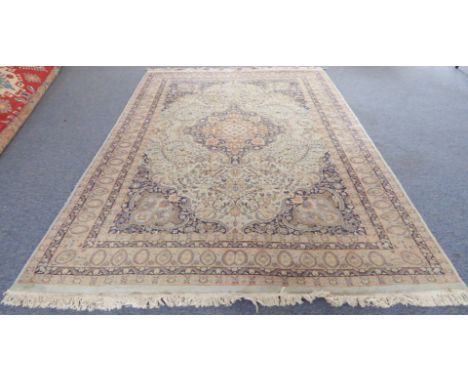 A large Kashmir carpet: light turquoise ground with central medallion and palmette spandrels, varying sized and coloured bord