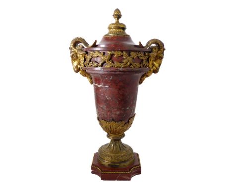 A 19th century gilt-metal-mounted and rouge variegated marble urn and cover: the domed cover surmounted with a pineapple fini