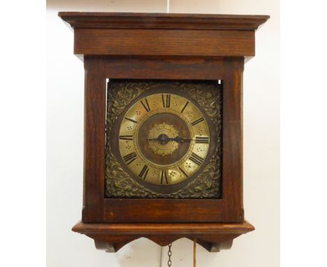 A late 17th century weight driven hooded wall clock: unsigned, the 8¼ in square brass dial with Roman chapter ring, brass mas