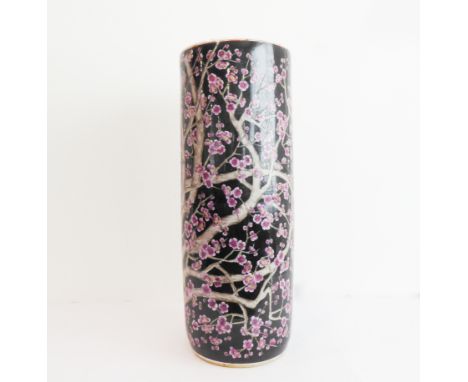 A Chinese porcelain stick-stand of cylindrical form and decorated in enamels with prunus blossom (23.5 cm in diameter and 62c