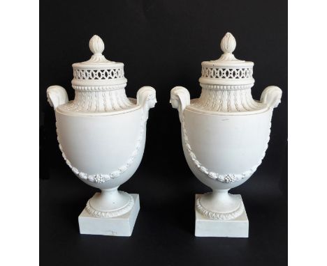 A large pair of 19th century basalt urn vases in neoclassical style: the reticulated covers with bud finials above Pharaoh-st