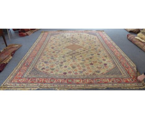 An early 20th century Turkish Sivas carpet: ivory field with three small central lozenges, all over stylised design of shrubs