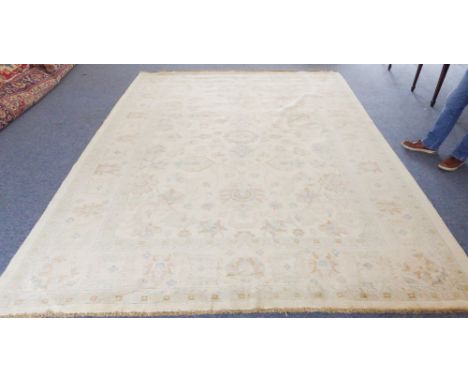 A large Pakistan Ziegler carpet: beige ground with large flowerheads and scrolling foliage (slight marking) (369cm long x 274