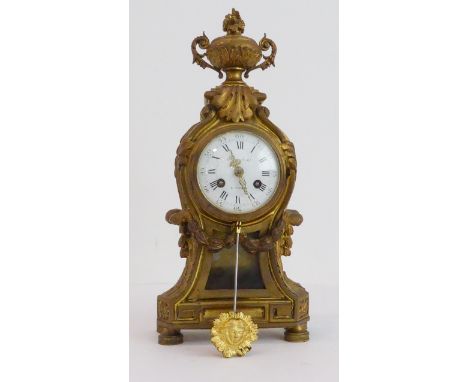 A 19th century French gilt-metal-cased eight-day mantle clock in Louis XVI style. The two-handled classical-style urn finial 